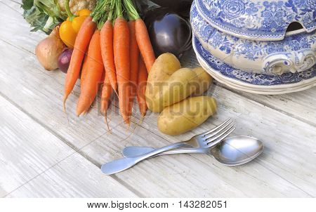vegetables for potage on a white table with bowl and tablespoon