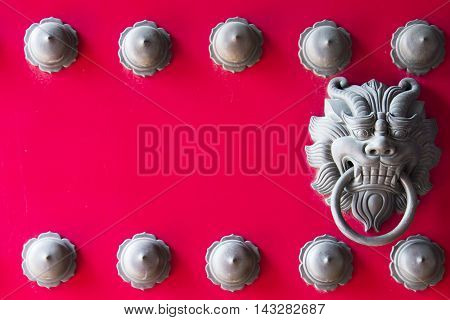 Lion knocker on the chinese traditional red door backgrounds