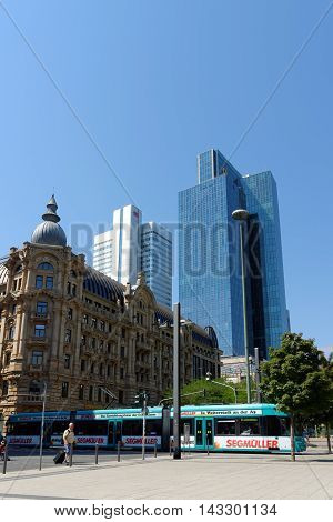 FRANKFURT AM MAIN GERMANY - AUGUST 7 2015: A tramcar on Willy-Bradt-Platz with the Silberturm (Silver Tower) and Gallileo skyscrapers in the background.