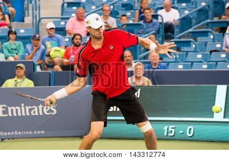 Mason Ohio - August 16 2016: John Isner in a match at the Western and Southern Open in Mason Ohio on August 16 2016.