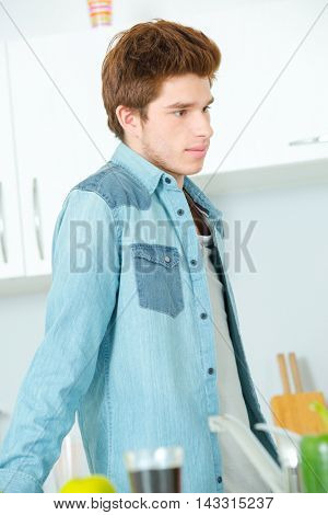 Teenager hanging around in the kitchen