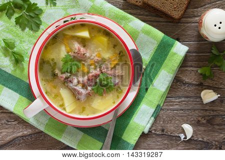 Delicious Rice Soup With Pieces Of Meat And Rye Bread On A Wooden Background. Top View .