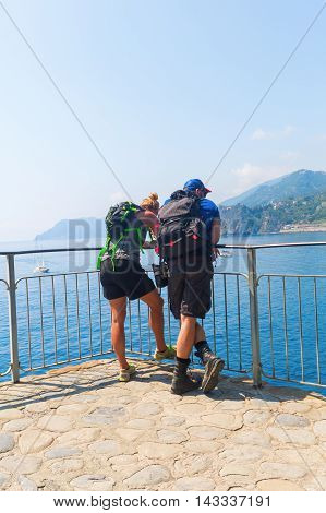 Hiking Couple Standing At The Coast Of The Cinqueterre, Italy
