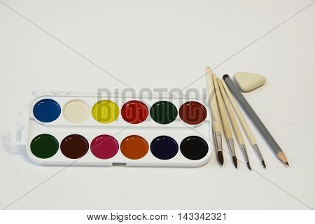 A set of colored paints and brush set for children's artistic creativity.
