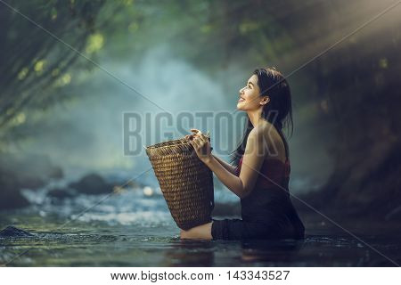 Happy Asian woman in cascade Thailand, Asia