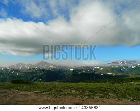 White clouds over the mountains of Kamchatka