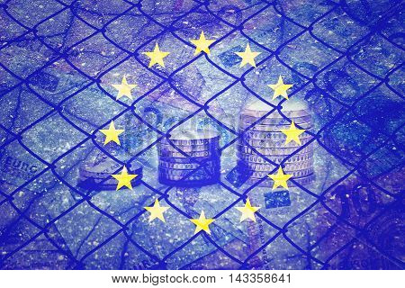 EU flag, euros, cracks and fence - Finance concept