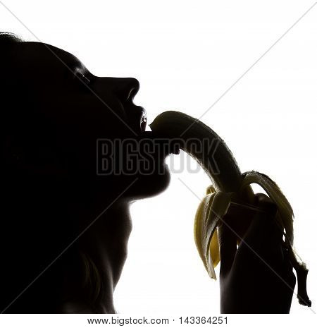 Young amazed woman in lacy lingerie holding a banana, she is going to eat a banana. she sucks a banana.