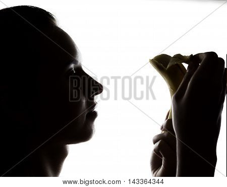 Young amazed woman in lacy lingerie holding a banana, she is going to eat a banana. she sucks a banana.