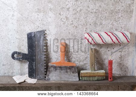 Construction tools on concrete background. Copy space for text. Set of assorted plaster trowel tools and spatula .