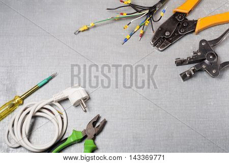 Set of electrical tool on wooden background. Accessories for engineering work, energy concept
