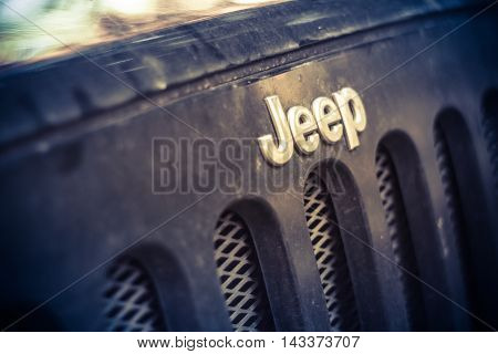Novgorod oblast, Russia , 03 August, 2015 , Jeep Wrangler on a rural road in the Novgorod region, the Jeep Wrangler is a compact four wheel drive off road and sport utility vehicle
