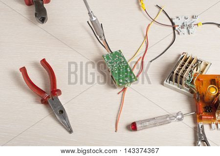 Set of electrical tool on wooden background. Accessories for engineering work, energy concept