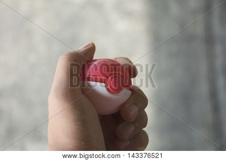 Thailand - August 20, 2016: Poke ball in Hand  (Pokemon Ball). Pokeball toy of the game Pokemon Go at Chon Buri, Thailand.