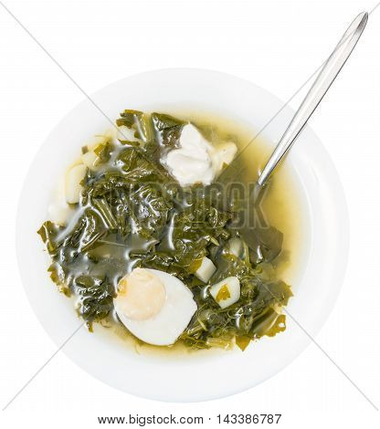 Top View Of Soup In Plate With Spoon From Greens