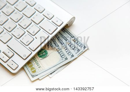 Concept image of finance and investment. 100 US dollars bank notes and money coins. with computer keyboard