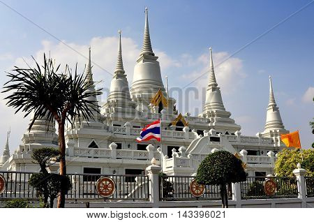 Samut Prakan Thailand - January 15 2013: The gleaming white Wat Asoke with its seven Chedis with ringed spires