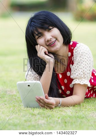 Asian Young woman using her tablet pc
