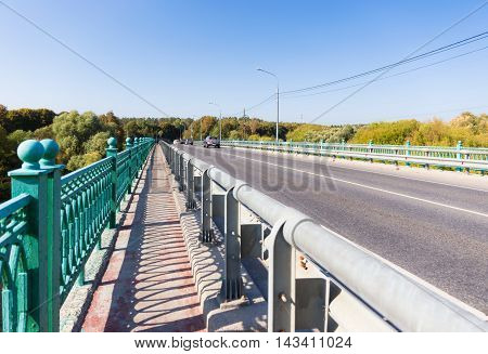 Fenced sidewalk on the bridge without cars