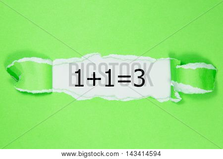 1+1=3 written under torn green paper.Business, technology, internet concept