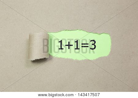 1+1=3 written under torn Brown paper.Business, technology, internet concept