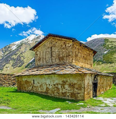 The building of Lamaria Church with the huge mountain range on the background Ushguli Georgia.