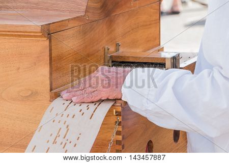 Man Plays The Barrel Organ In The Street