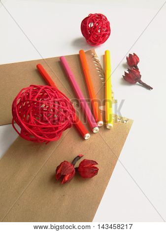 Copyspace blank sheets of craft paper covered with multiple colorful felt pen markers and dried flowers