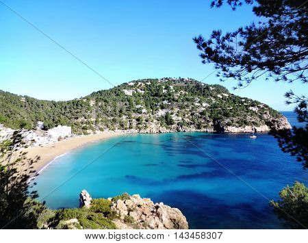 Beach Cala San Vicent on ibiza Island, turquoise water and blue sky.