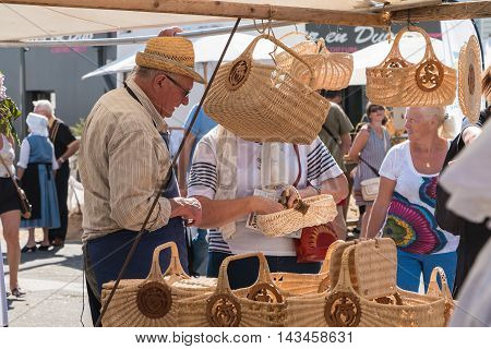 Man Sells Wicker Baskets On A Market
