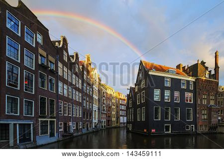 Famous Amsterdam canal with beautiful rainbow, Netherlands