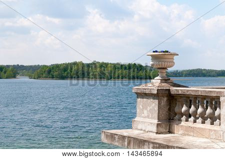 Bowl with flowers with Galve lake in background Uzutrakio palace Trakai Lithuania