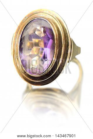 Precious gold ring with purple gemstone. Isolated on white background.