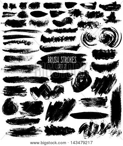 Brush hatches set. Black painted elements of unusual shapes on white background. Expressive isolated brush strokes.
