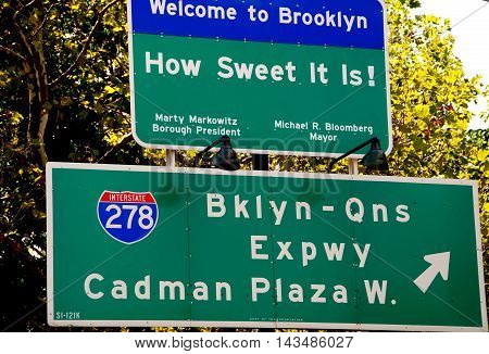 Brooklyn New York - August 13 2007: Signs at the end of the Brooklyn Bridge extend a welcome to the borough of Brooklyn