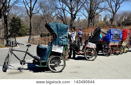 New York City - April 1 2014: A row of tourist pedicabs parked at Cherry Hill in Central Park
