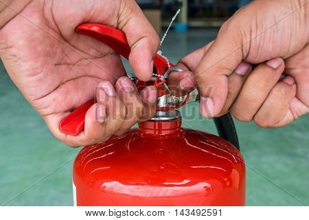 Hand pulling pin of fire extinguisher, protection, illustration