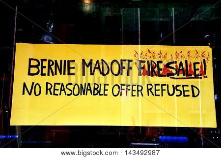 New York City - July 24 2009: Amusing Bernie Madoff fire sale sign in a guitar shop on West 23rd Street in Chelsea