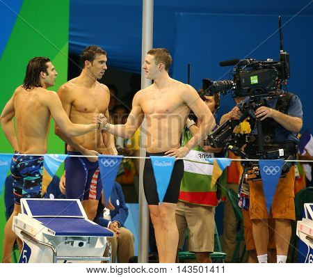 RIO DE JANEIRO, BRAZIL - AUGUST 13, 2016: USA Men's 4x100m medley relay team Cory Miller (L),  Michael Phelps and Ryan Murphy  celebrate victory at the Rio 2016 Olympic Games