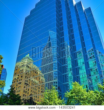 Reflecting city buildings in glasshaped skyscraper building