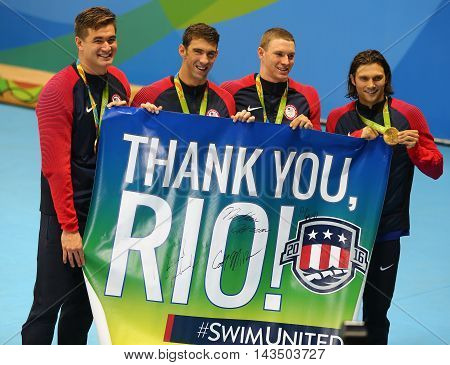 RIO DE JANEIRO, BRAZIL - AUGUST 13, 2016: USA Men's 4x100m medley relay team Nathan Adrian(L),  Michael Phelps, Ryan Murphy and Cory Miller celebrate victory at the Rio 2016 Olympic Games
