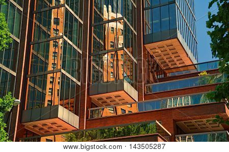 Cubed composed building mirror balcony green leaves