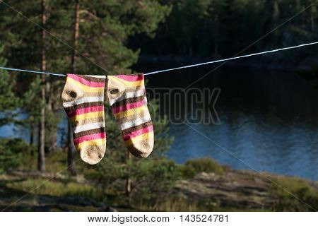 Bright socks drying after washing on the clotheline outdoors