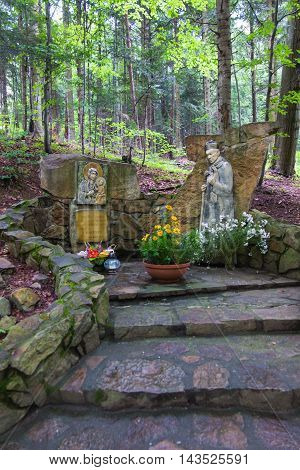 Komancza Poland - July 20 2016: Chapel of Mary and the figure of the Polish primate Cardinal Wyszynski the woods next to the convent of the Sisters of Nazareth in Komancza. From 1955 to 1956 the monastery was interned Cardinal Stefan Wyszynski