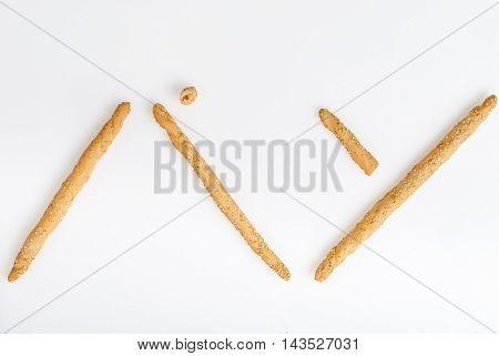 Excellent and natural breadsticks with sesame seeds with them clearly visible on the surface Arranged so that they form the Japanese Kanji ideogram for bread and isolated on white background