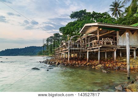 bungalow for backpackers on a tropical beach in evening time. Thailand