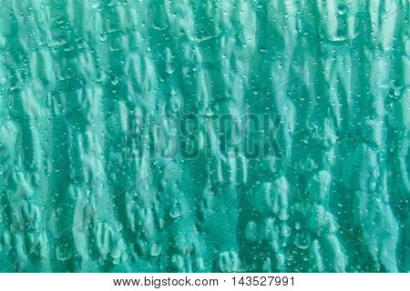 Rainy abstract background - Abstract greenish background wet and sprinkled with water drops, also a great pattern.