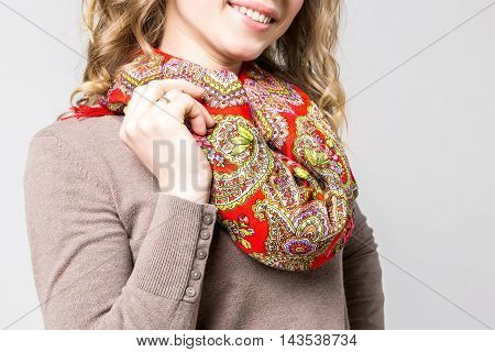 Closeup photo of fashoinable neckerchief with traditional ornaments on beautiful woman