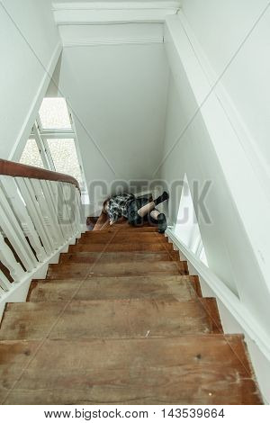 Motionless Injured Boy Lying On The Stairs