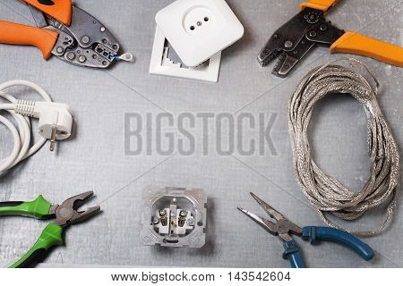 Set of electrical tool on wooden background. Accessories for engineering work, energy concept